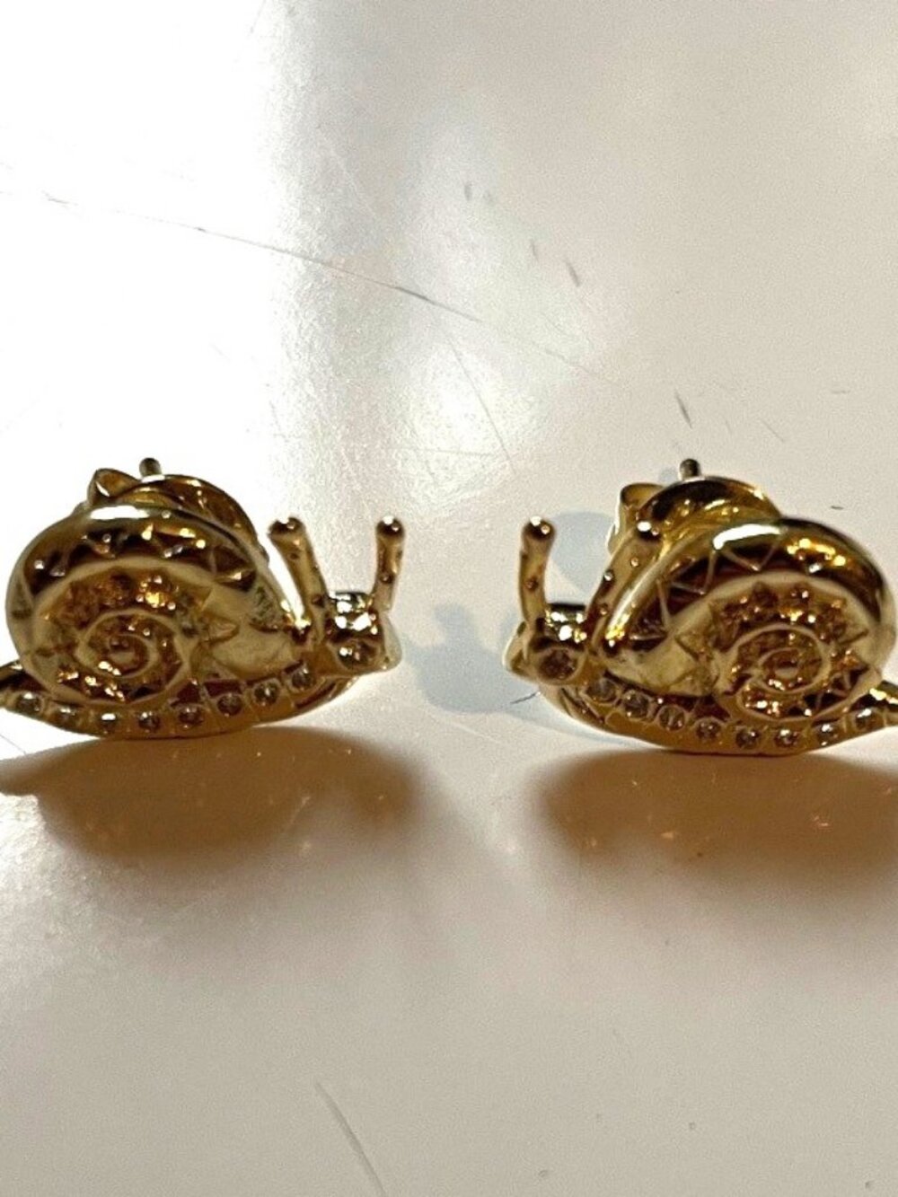 EARRINGS: Gold snail earrings. EUC.